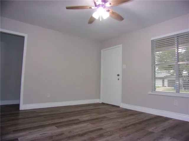 a view of a yard with wooden fence