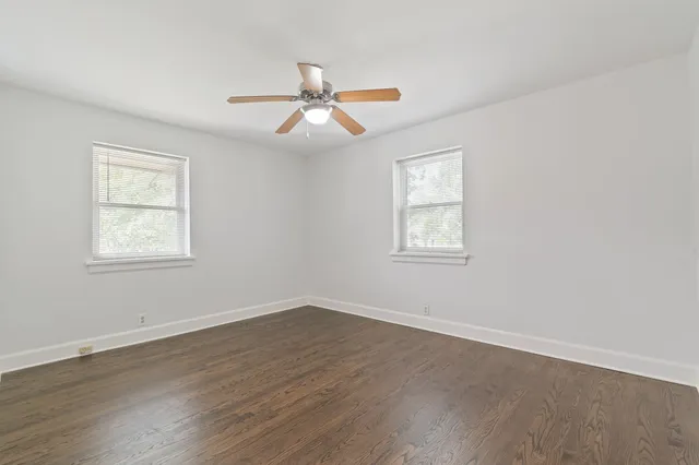 a view of a room with wooden floor and windows