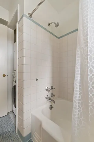 a bath room with a shower and a sink