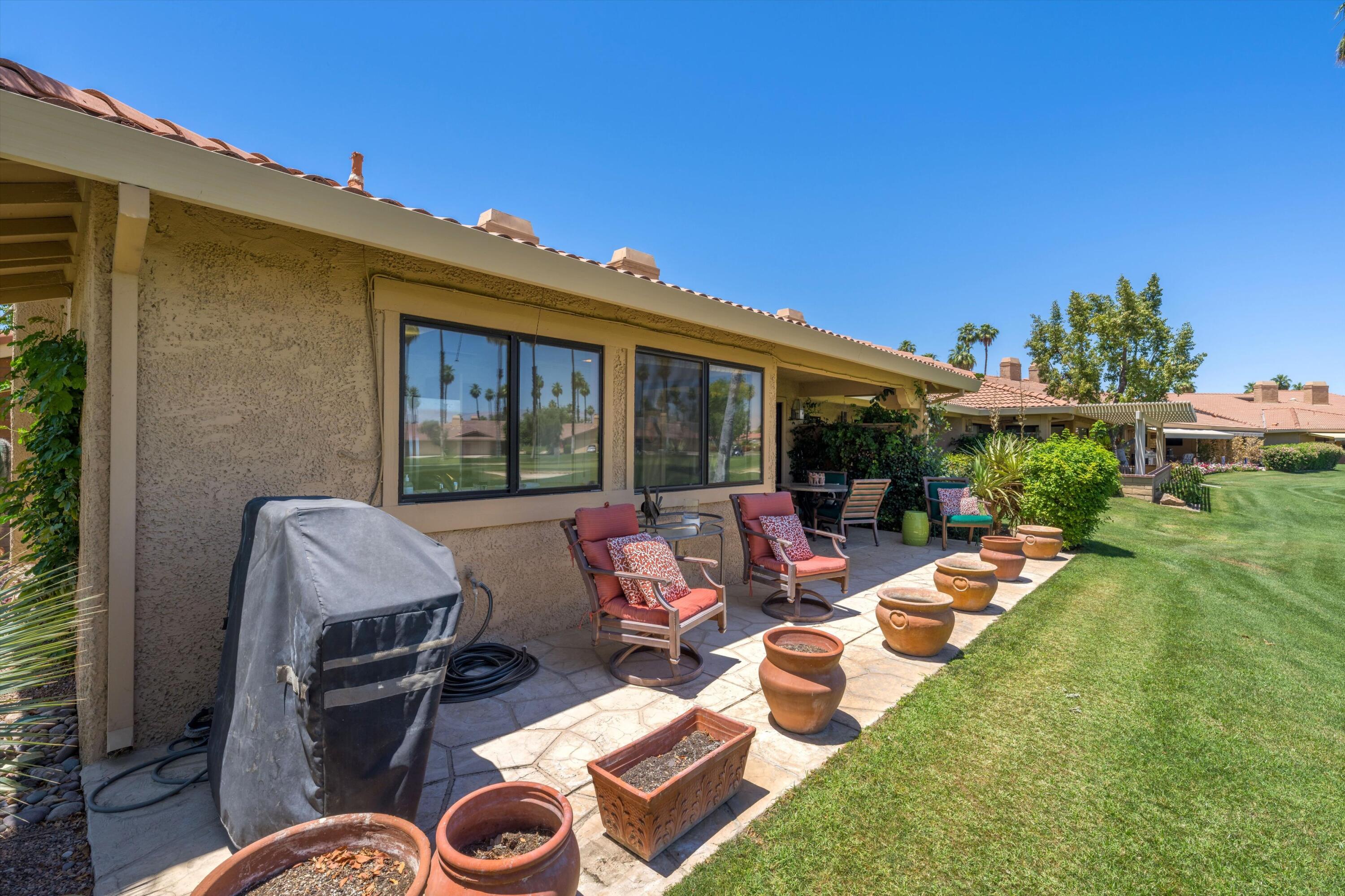56 Maximo Way Palm Desert, CA 92260 - Photo 12 of 29 a view of backyard with outdoor seating and plants