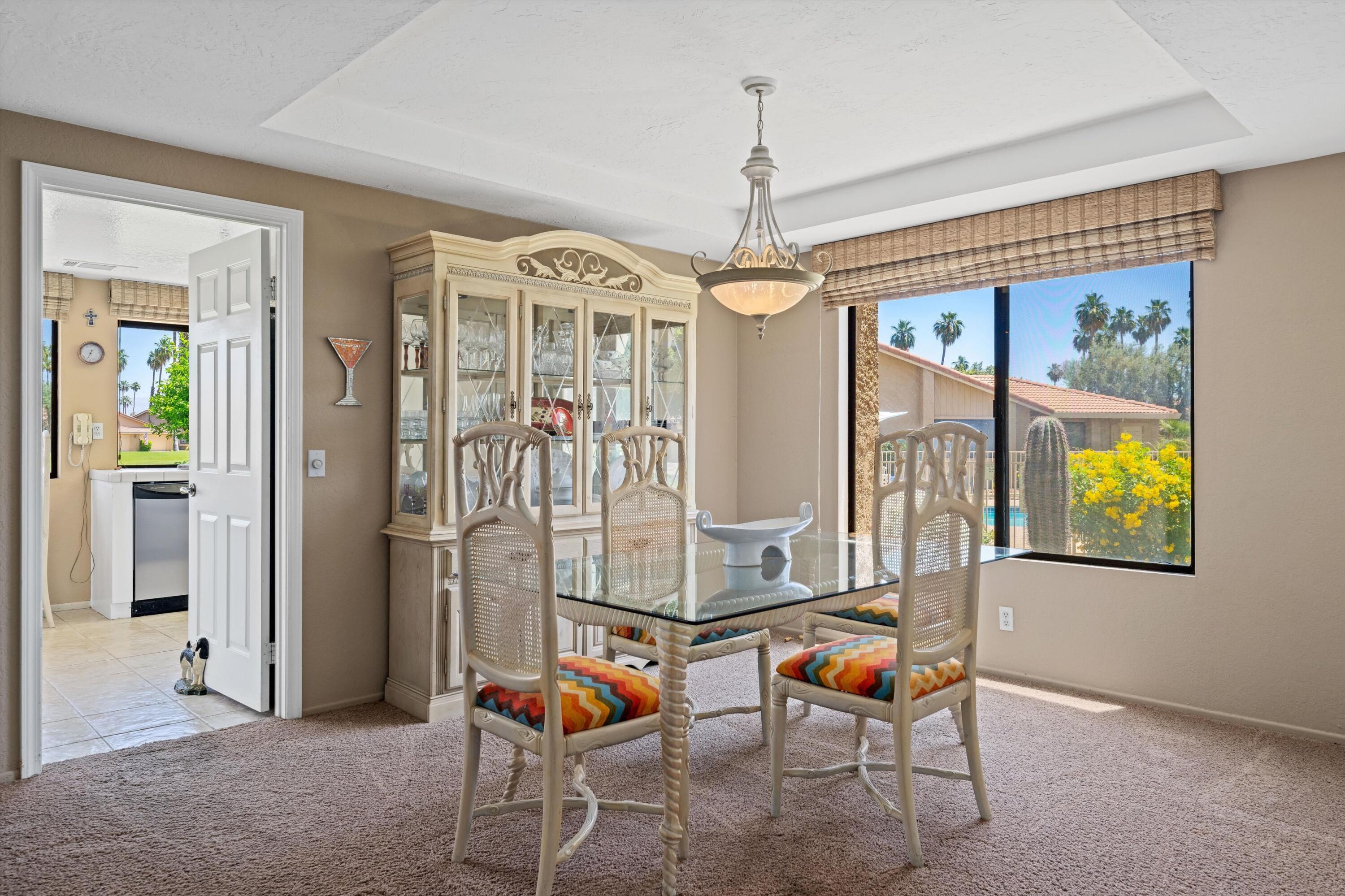 56 Maximo Way Palm Desert, CA 92260 - Photo 13 of 29 a living room with furniture and a chandelier