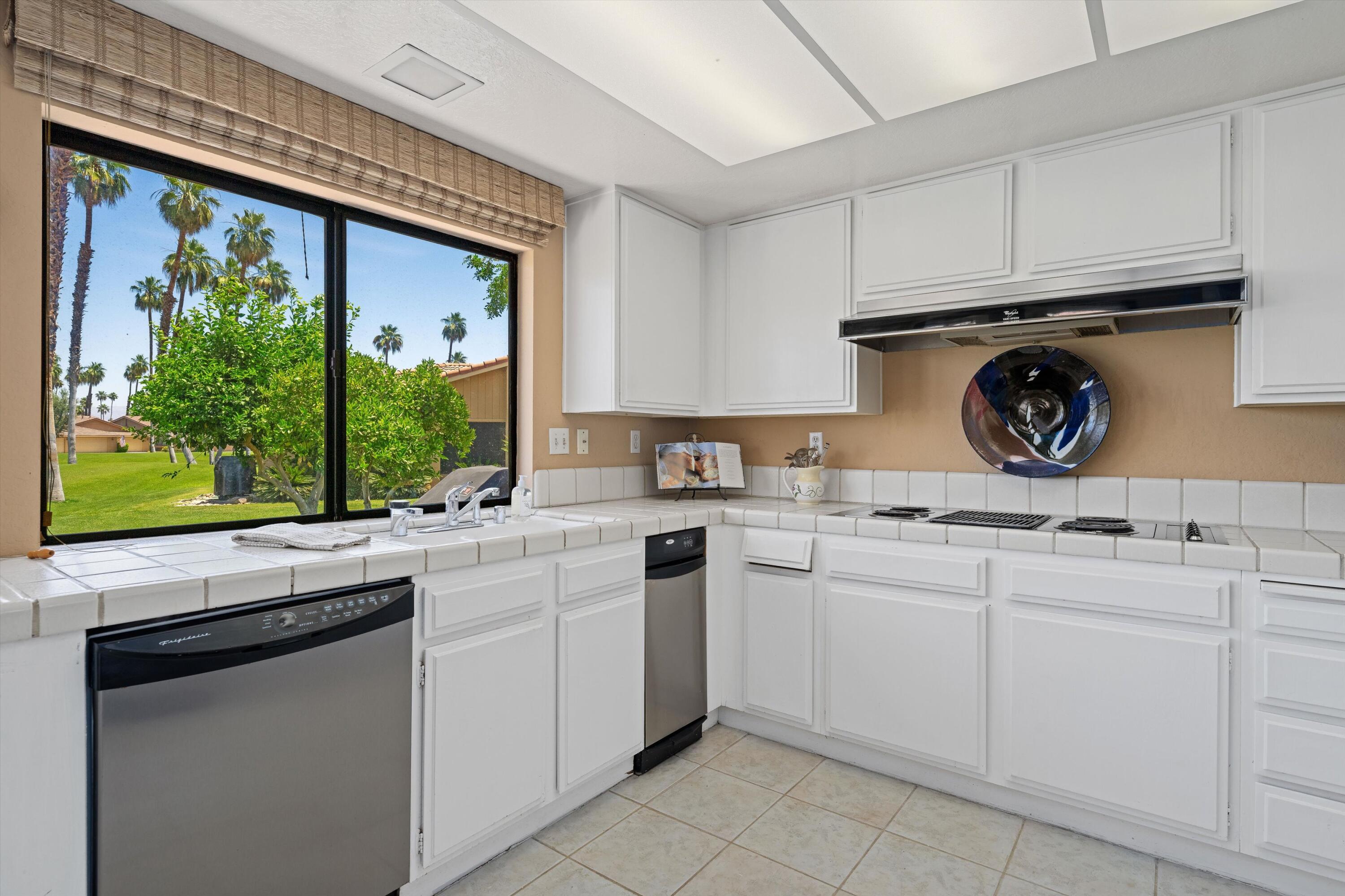 56 Maximo Way Palm Desert, CA 92260 - Photo 14 of 29 a kitchen with appliances cabinets and a sink
