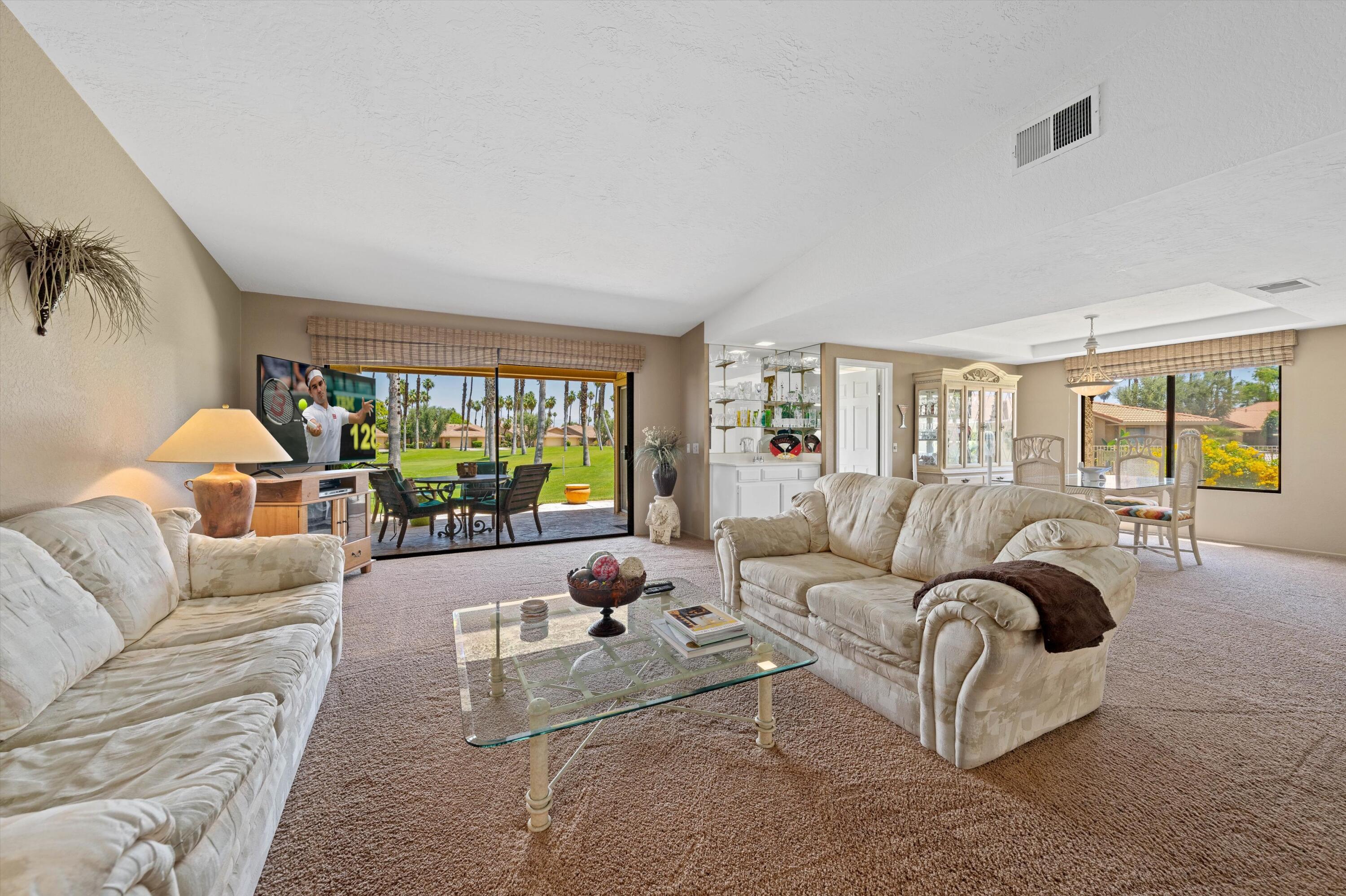 56 Maximo Way Palm Desert, CA 92260 - Photo 17 of 29 a living room with furniture and a large window