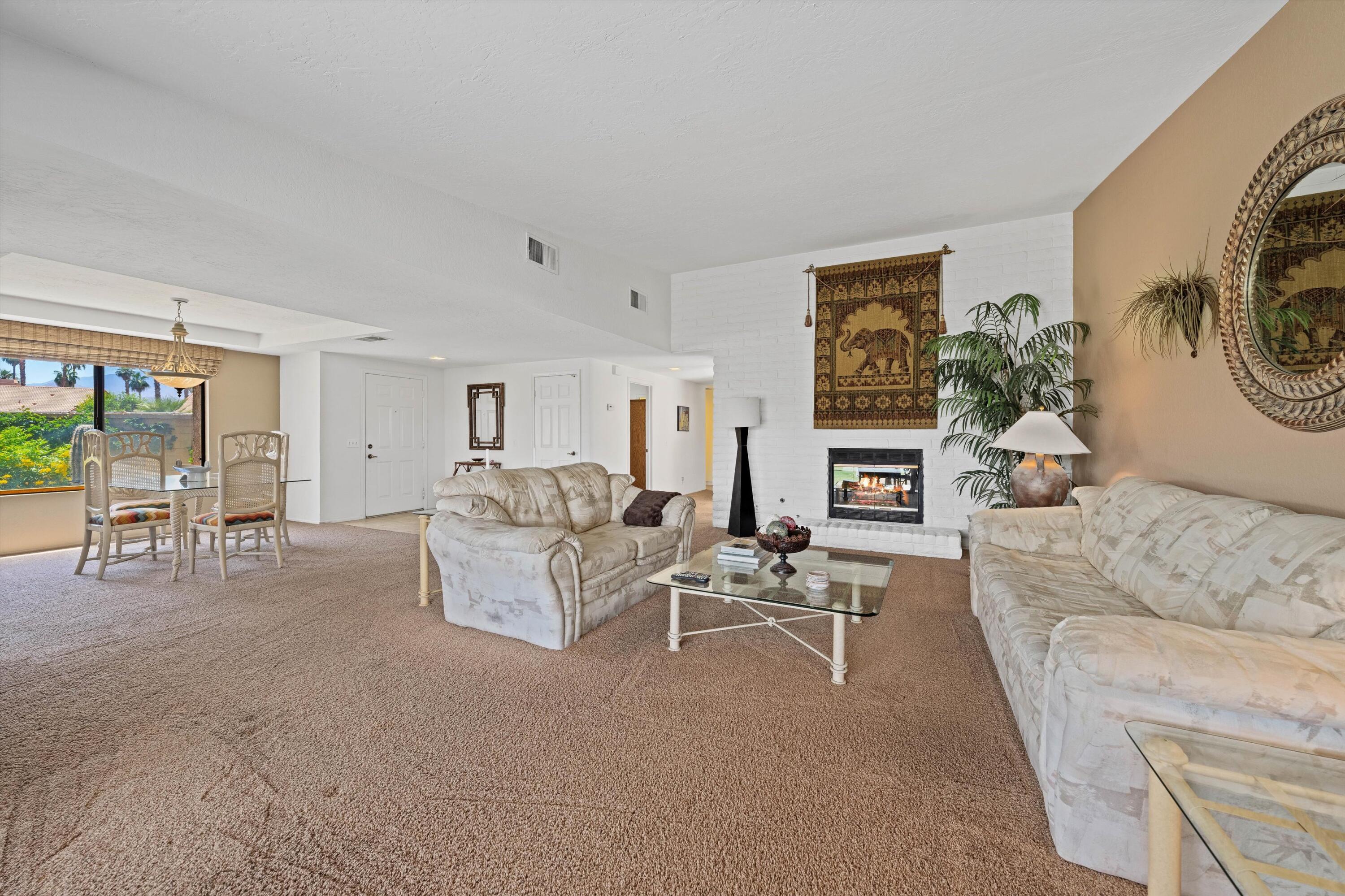 56 Maximo Way Palm Desert, CA 92260 - Photo 20 of 29 a living room with furniture and a large window