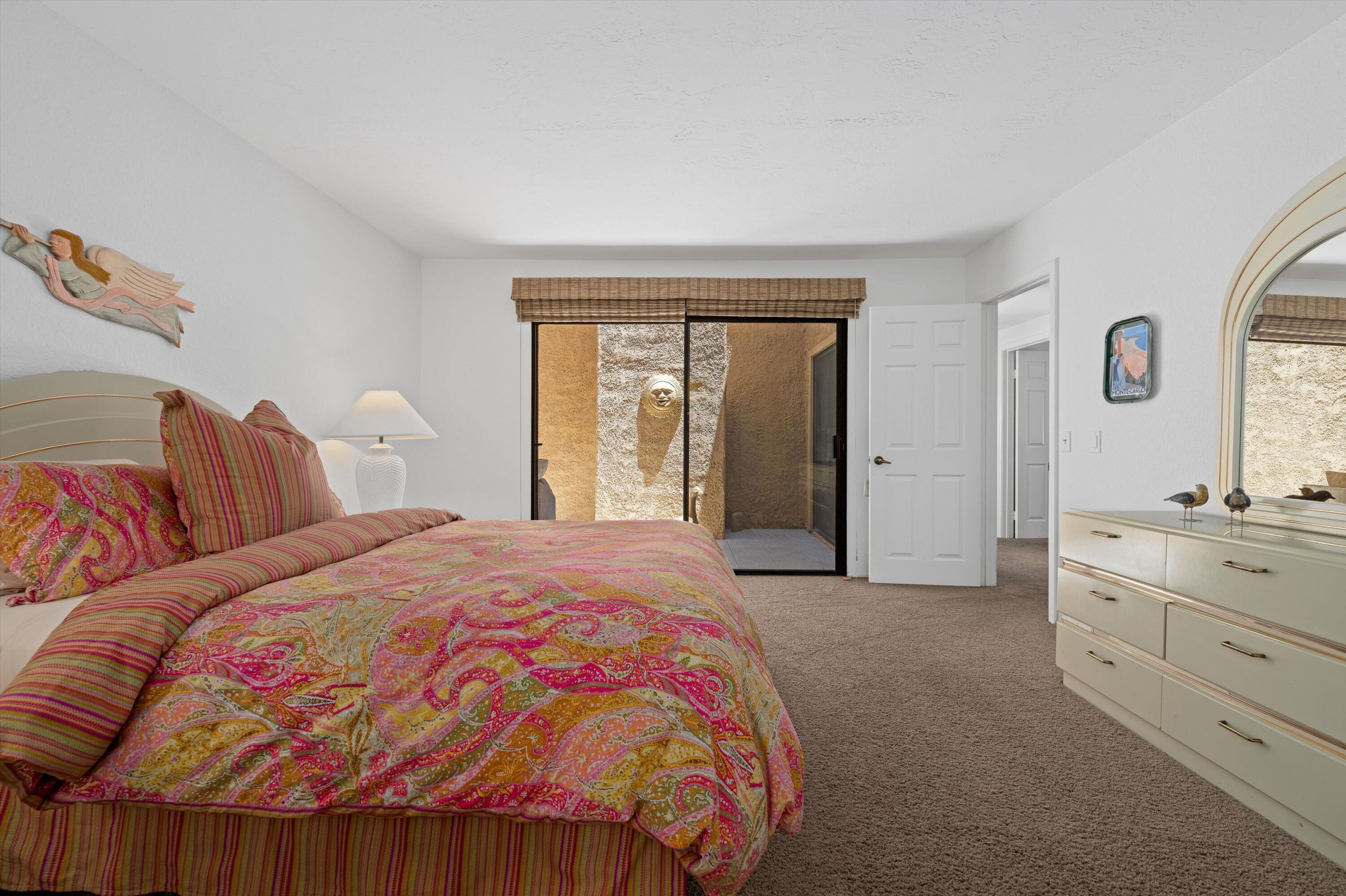 56 Maximo Way Palm Desert, CA 92260 - Photo 24 of 29 a bedroom with a bed and a dresser