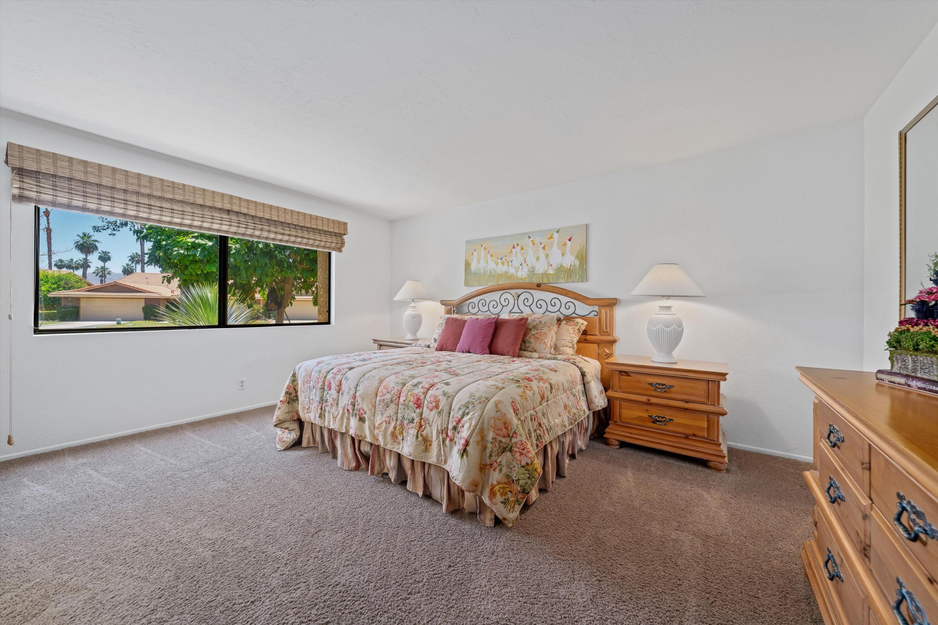 56 Maximo Way Palm Desert, CA 92260 - Photo 26 of 29 a spacious bedroom with a bed and a window