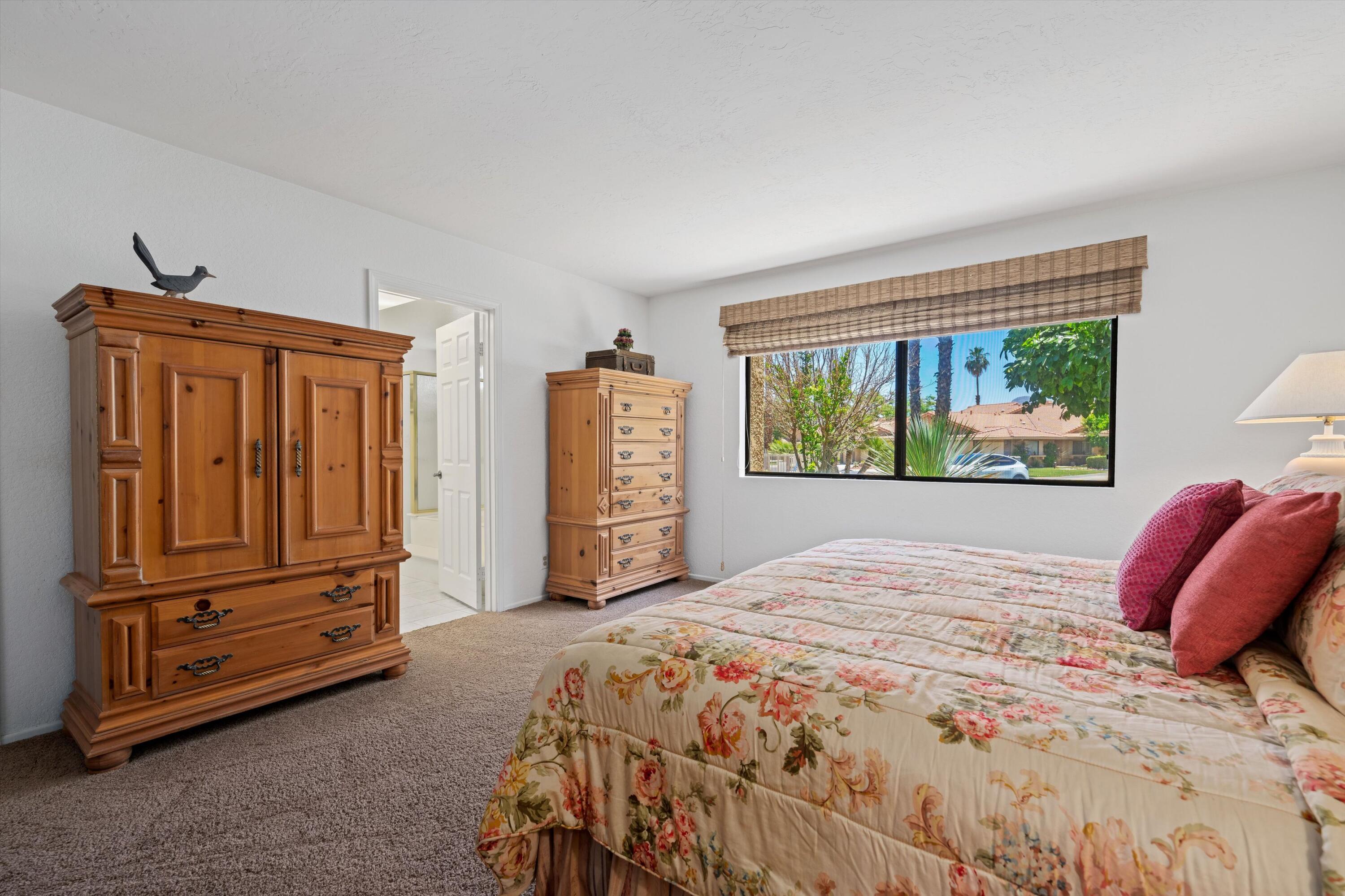56 Maximo Way Palm Desert, CA 92260 - Photo 27 of 29 a bedroom with a bed and a dresser next to a window