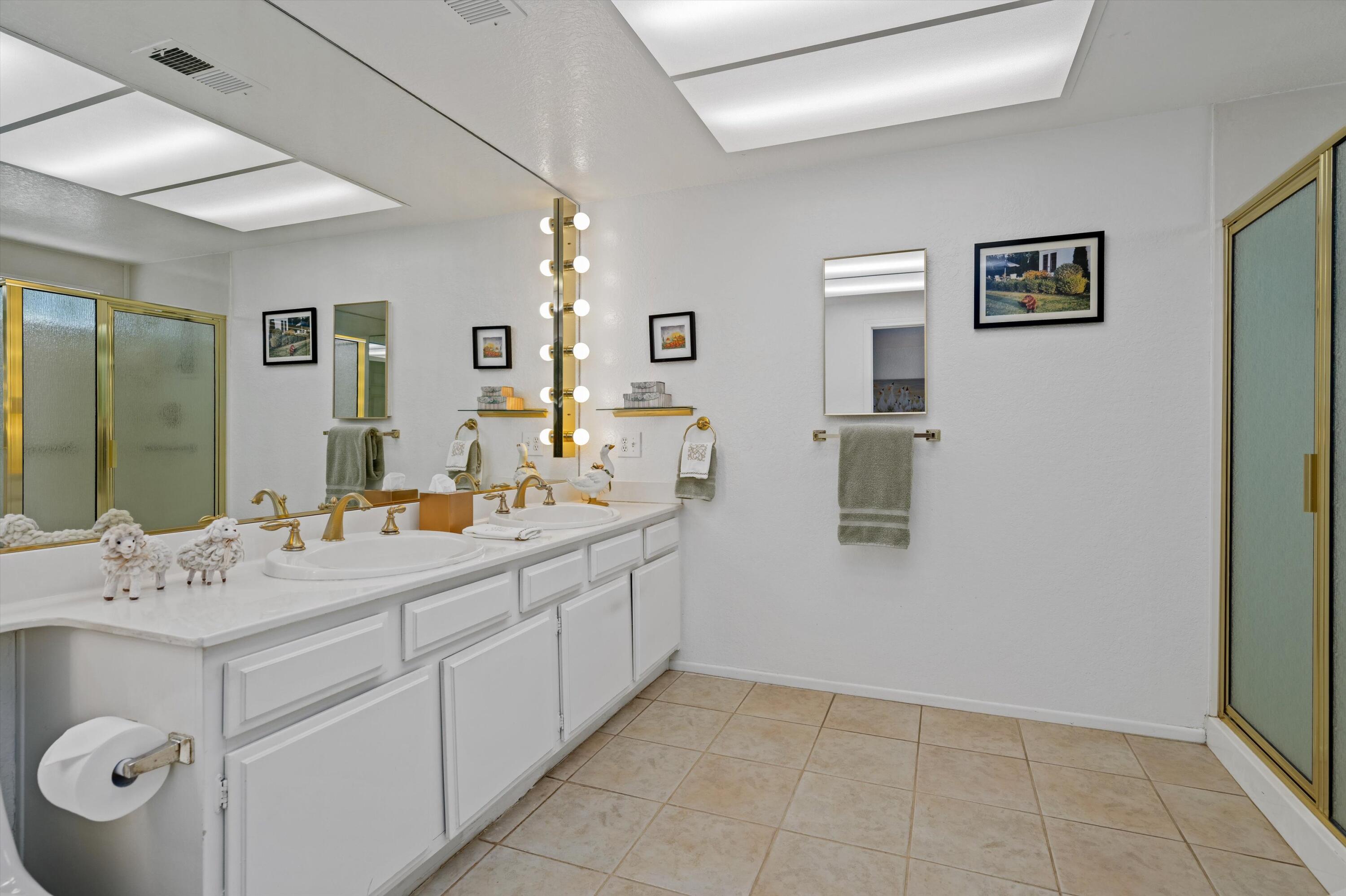 56 Maximo Way Palm Desert, CA 92260 - Photo 28 of 29 a bathroom with a double vanity sink mirror and toilet
