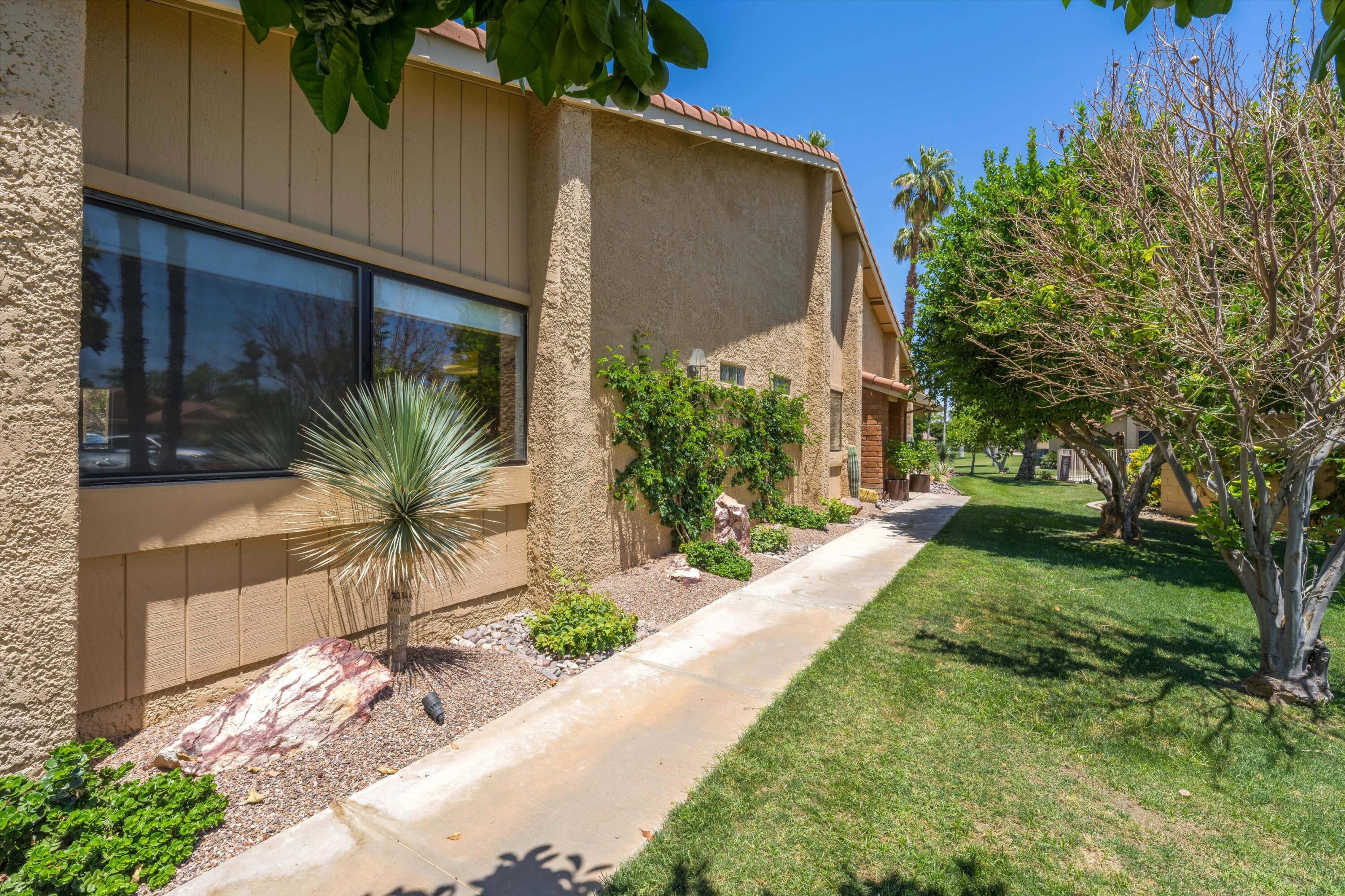 56 Maximo Way Palm Desert, CA 92260 - Photo 3 of 29 a front view of a house with garden