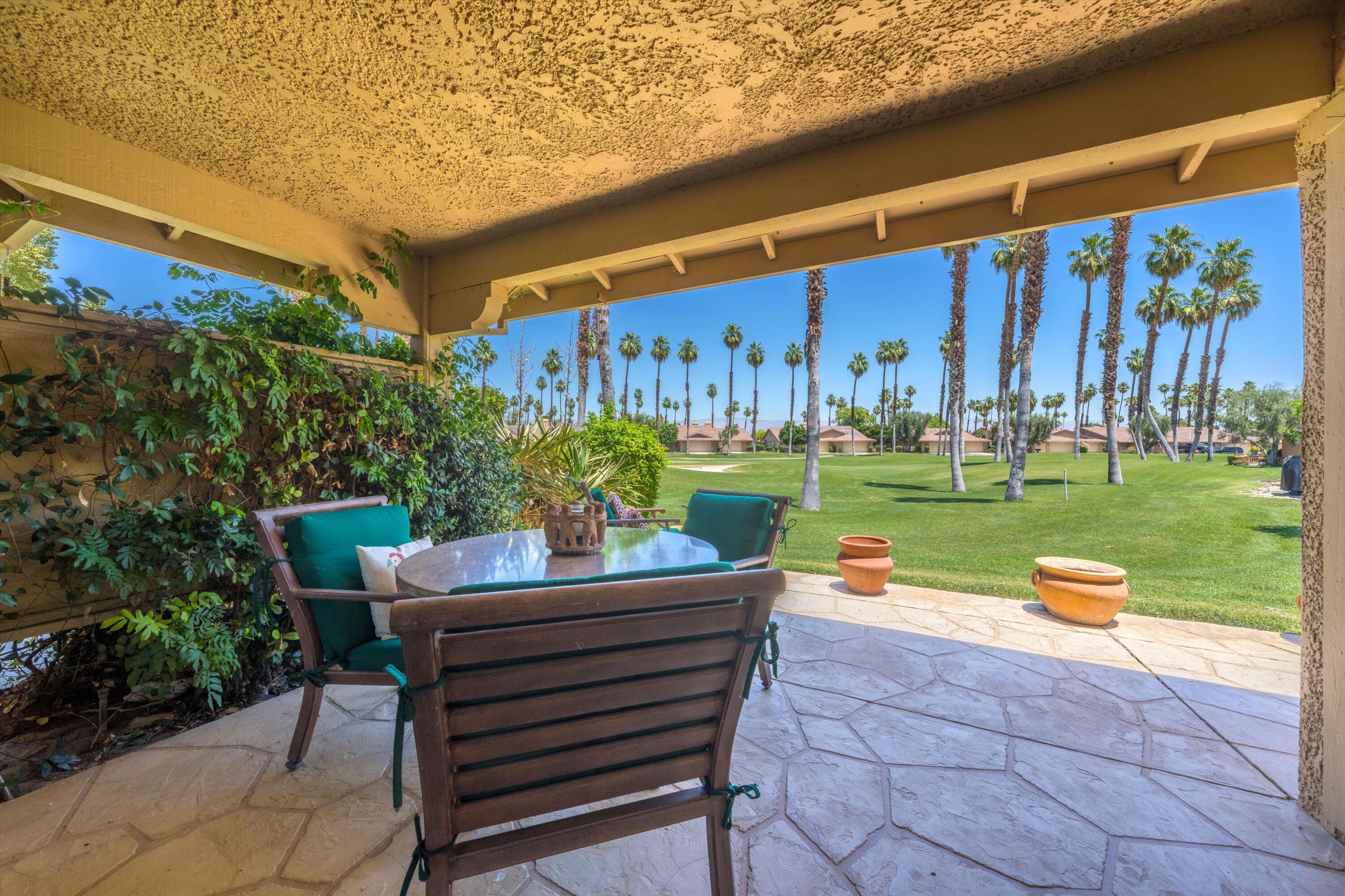 56 Maximo Way Palm Desert, CA 92260 - Photo 9 of 29 a backyard of a house with outdoor seating
