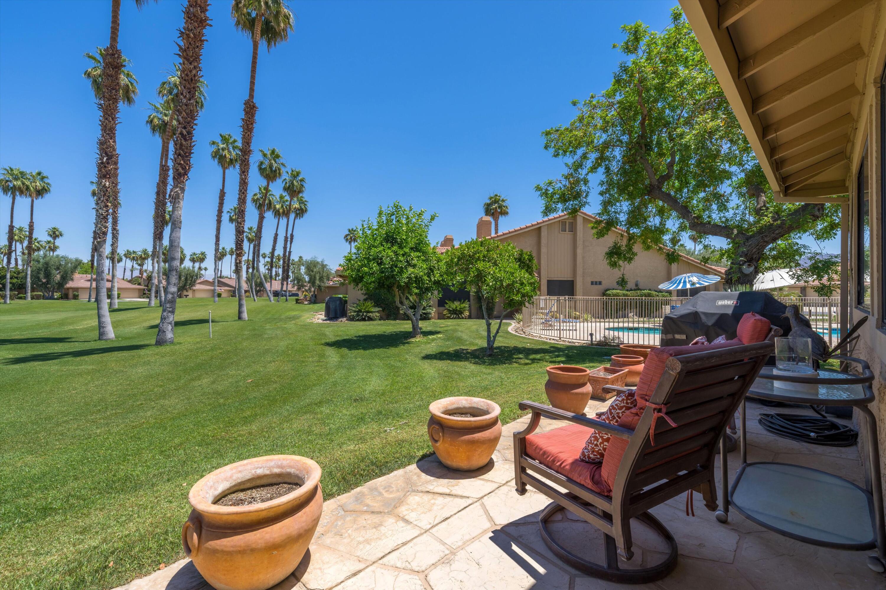 56 Maximo Way Palm Desert, CA 92260 - Photo 10 of 29 a backyard of a house with table and chairs