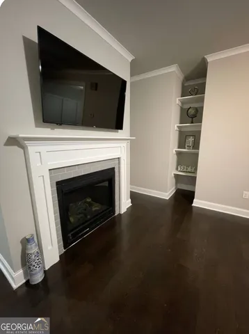 a living room with a fireplace and a flat screen tv