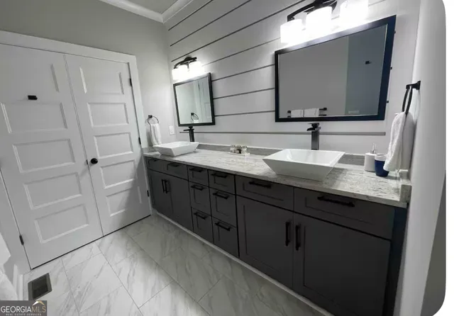 a bathroom with a double vanity sink and mirror