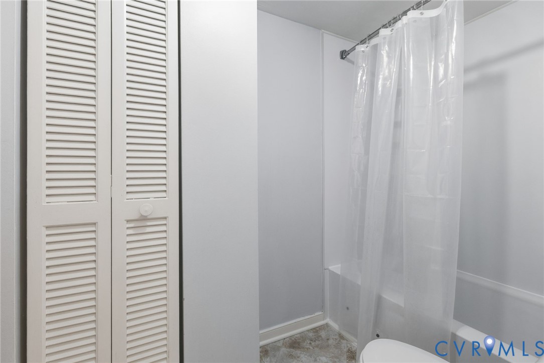 2655 Chancer Drive Henrico, VA 23233 - Photo 15 of 24 a bathroom with a shower curtain and a toilet