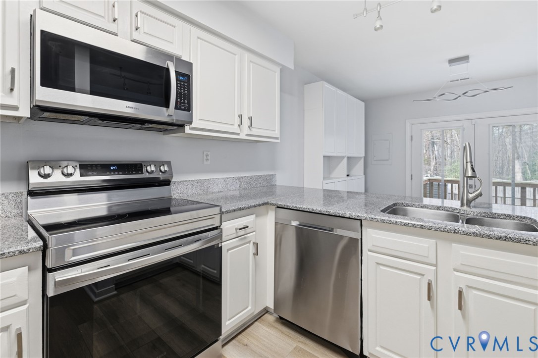 2655 Chancer Drive Henrico, VA 23233 - Photo 4 of 24 a kitchen with stainless steel appliances granite countertop white cabinets and stove