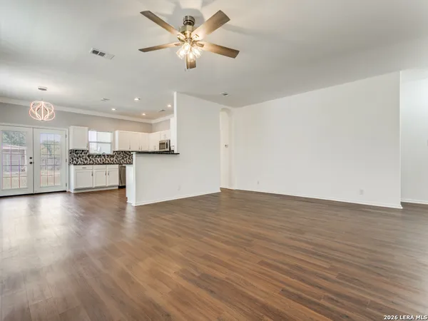 a view of a kitchen with a stove cabinets and wooden floor