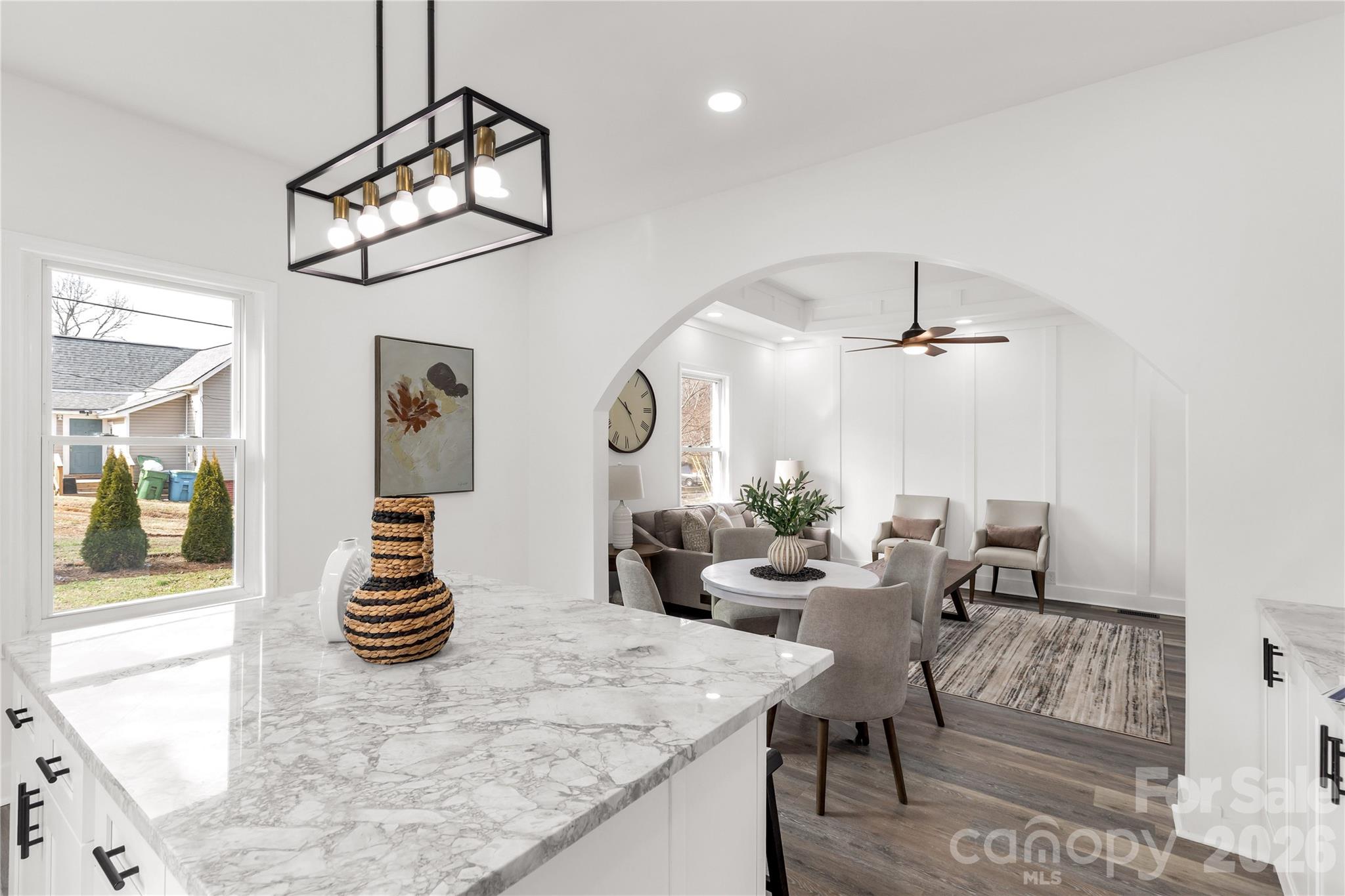 203 Jackson Street Fort Mill, SC 29715 - Photo 11 of 27 a view of a dining room and livingroom with furniture wooden floor a chandelier