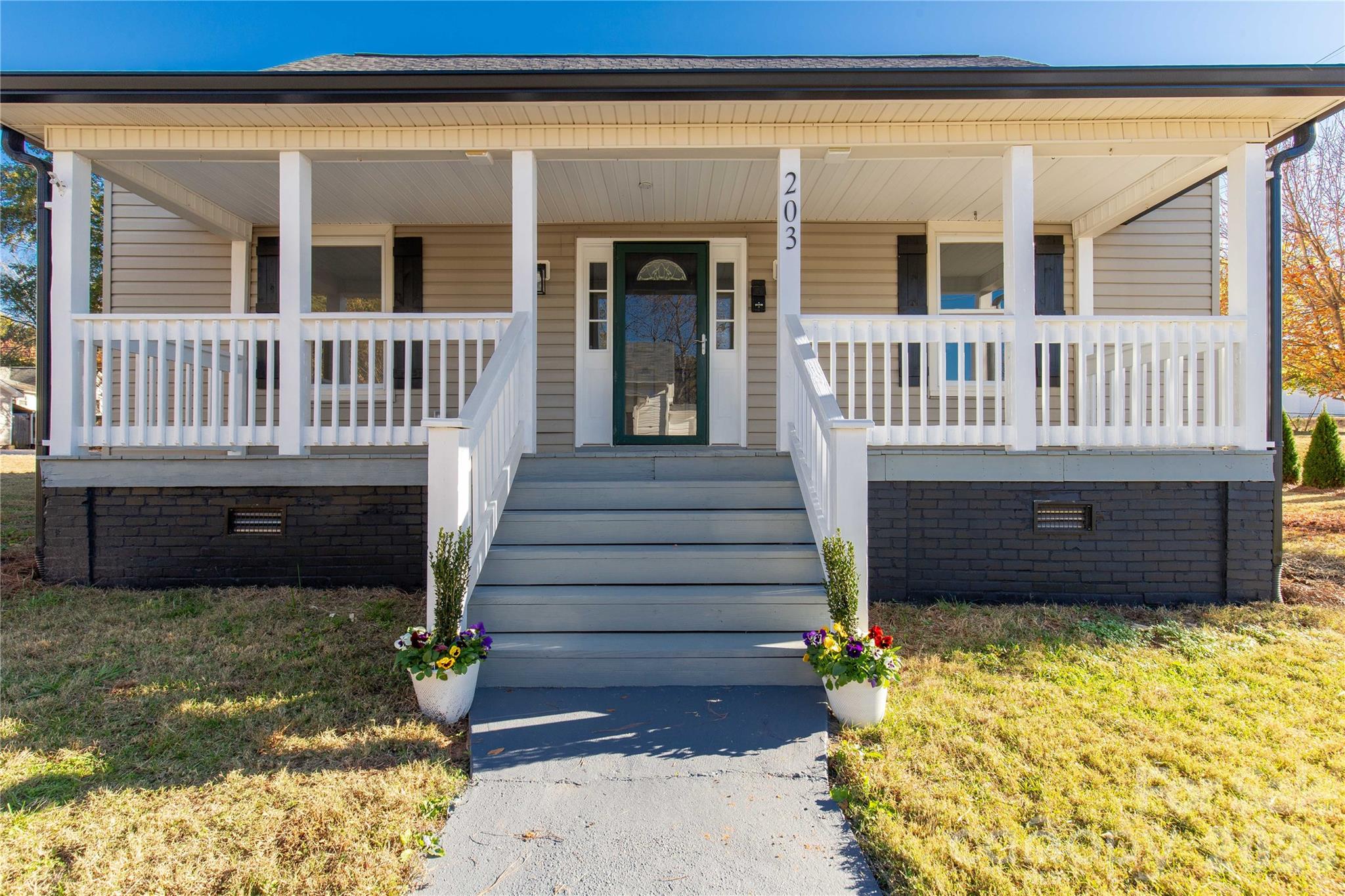 203 Jackson Street Fort Mill, SC 29715 - Photo 20 of 27 a view of a house with a small yard and wooden fence