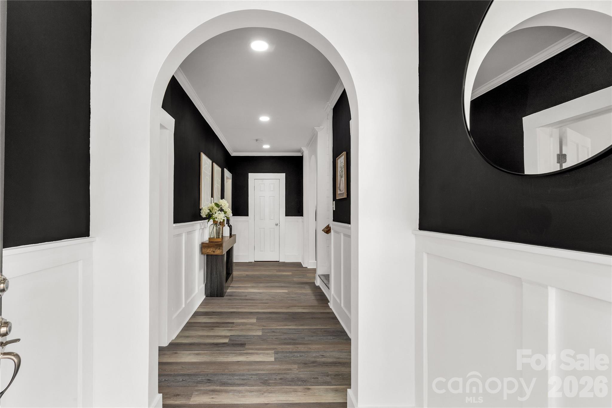 203 Jackson Street Fort Mill, SC 29715 - Photo 2 of 27 a view of a hallway with wooden floor and staircase
