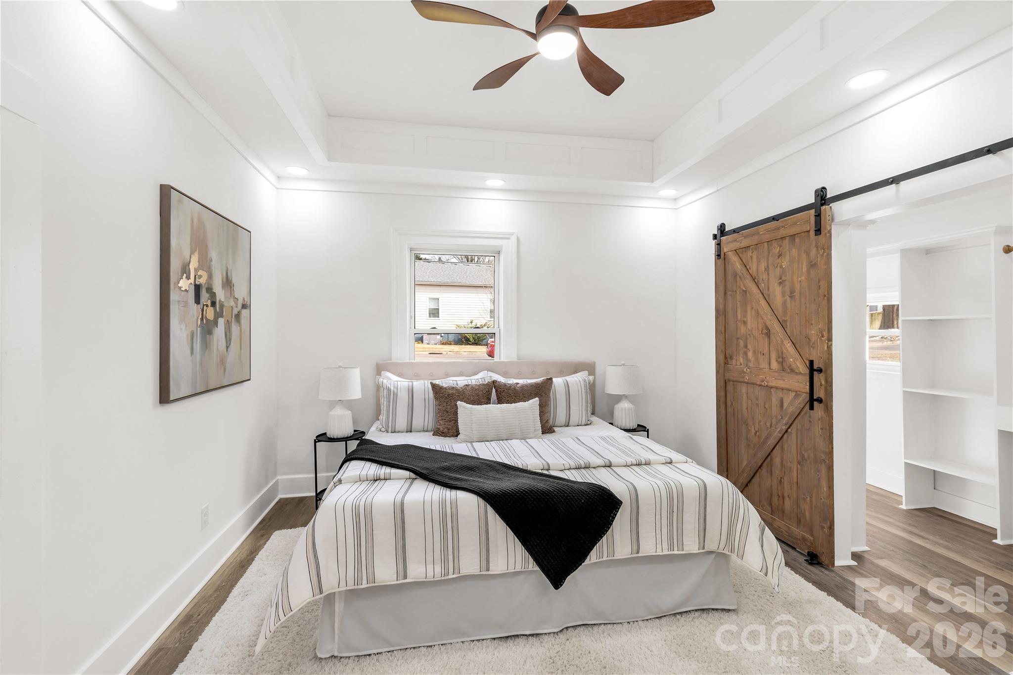 203 Jackson Street Fort Mill, SC 29715 - Photo 6 of 27 a bedroom with a bed and ceiling fan