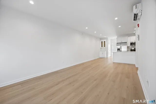 a view of a kitchen with a sink and wooden floor