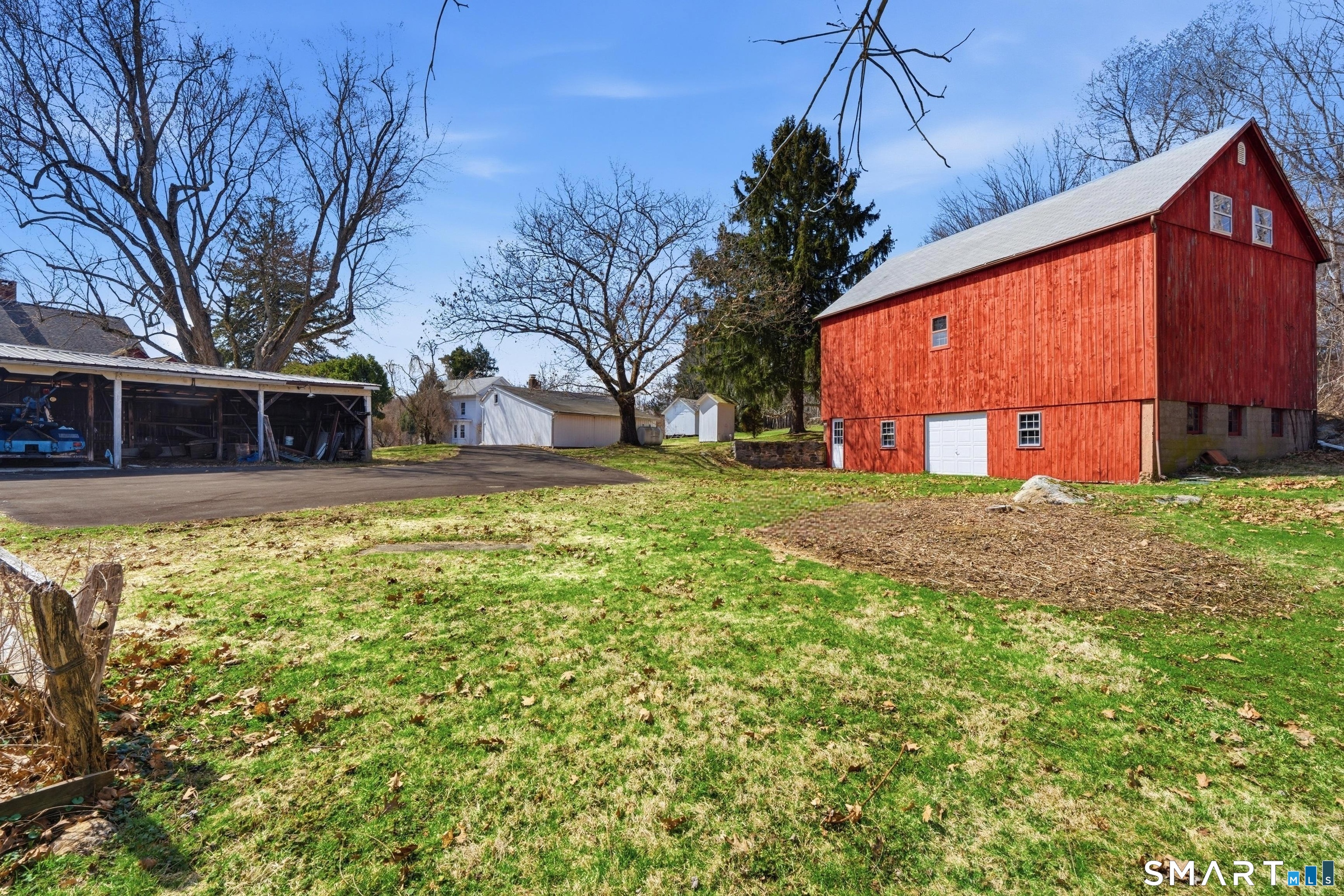 The red bank barn is huge. use to hold the goats in the lower level and around back you could drive equipment onto that level. Inside there are 3/4 levels