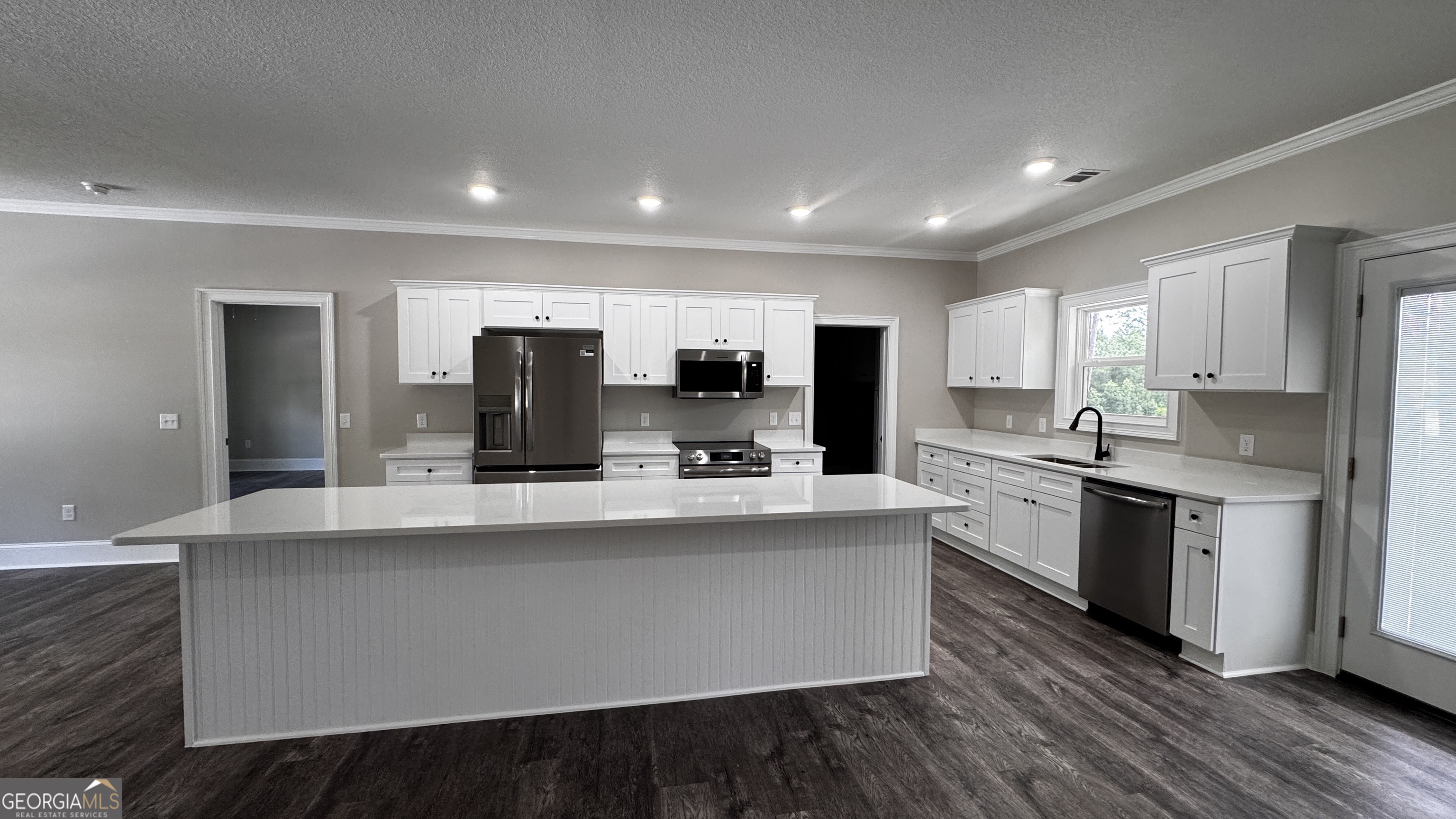 3 Willow Pointe Claxton, GA 30417 - Photo 12 of 31 a large kitchen with kitchen island a sink and a stove top oven