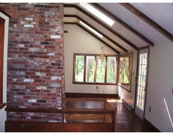 a kitchen with granite countertop a stove a sink and a refrigerator