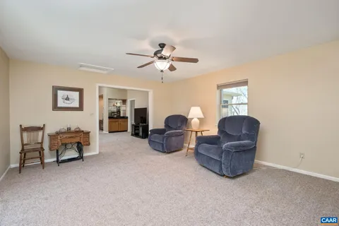 a living room with furniture and a ceiling fan
