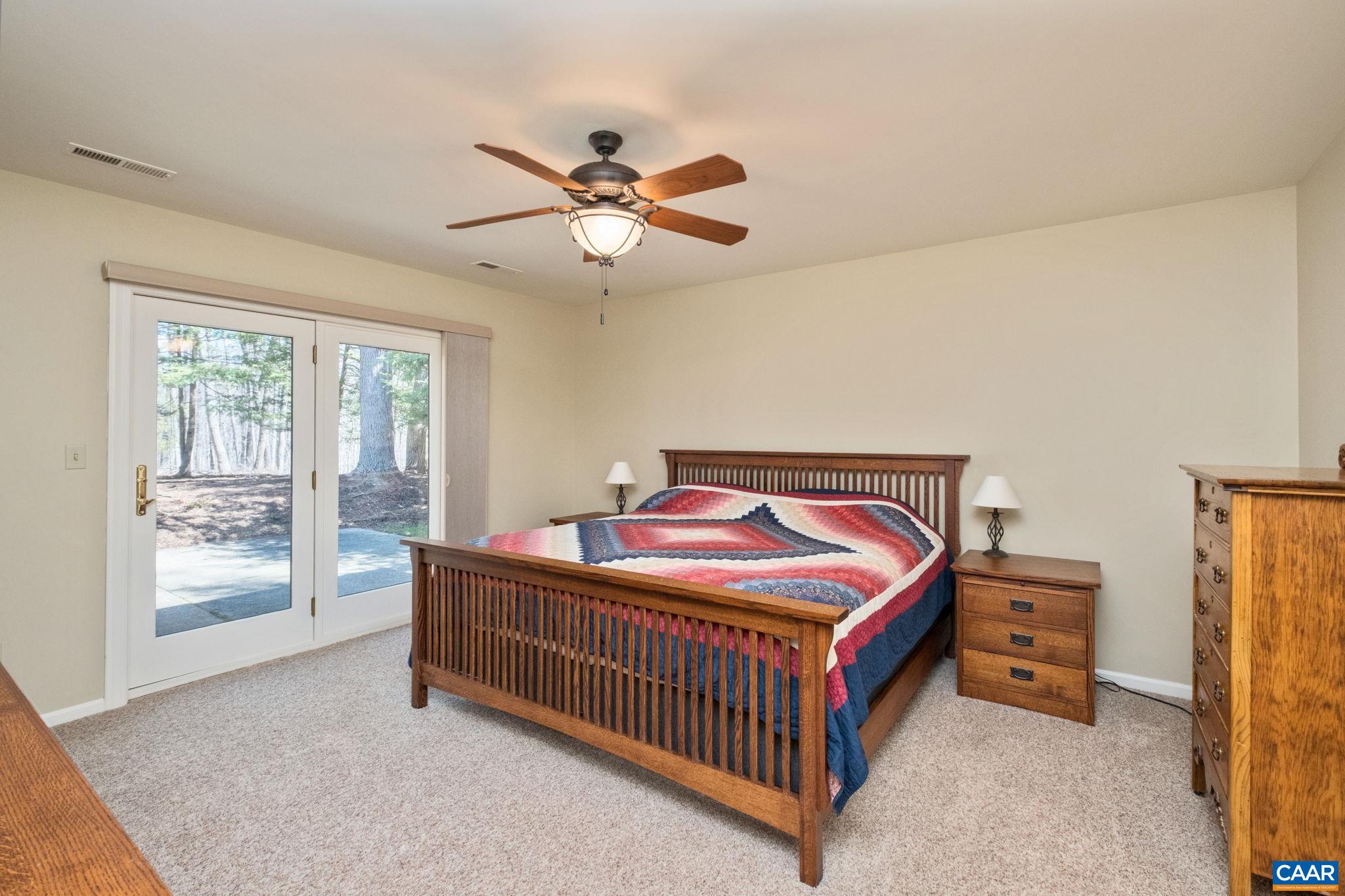 240 Homestead Lane Charlottesville, VA 22902 - Photo 16 of 32 a bedroom with a bed and a chandelier