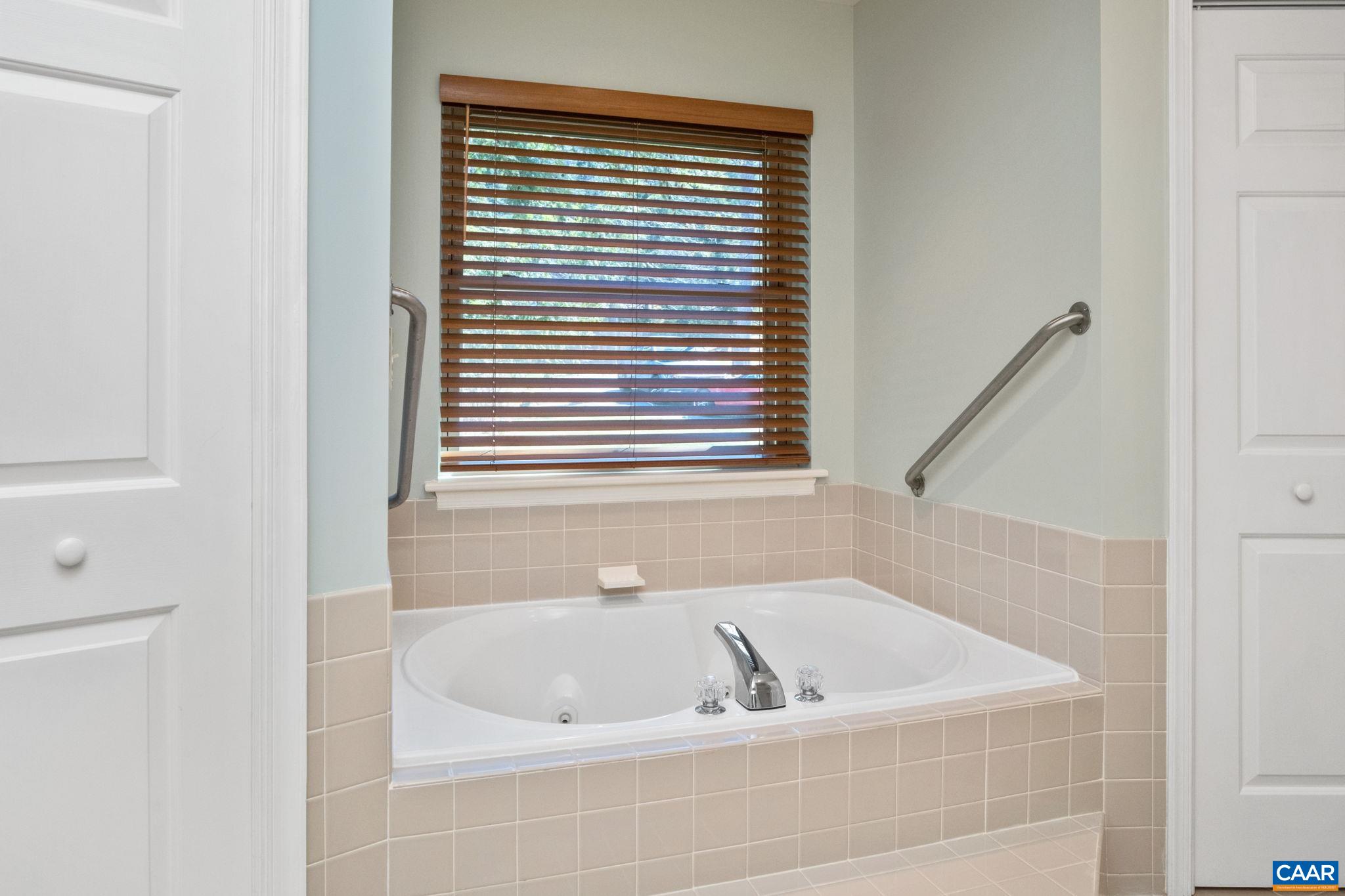 240 Homestead Lane Charlottesville, VA 22902 - Photo 19 of 32 a bath tub sitting in a bathroom next to a window