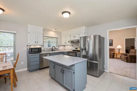 a kitchen with a refrigerator sink and stove
