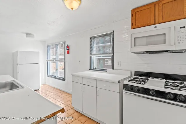 a kitchen with a sink cabinets and appliances