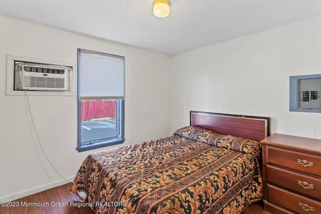 a bed room with a bed and painting on the wall