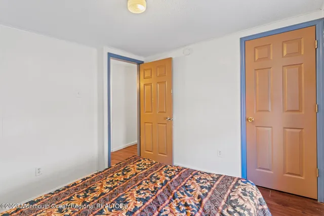 a bedroom with two beds and a lamp