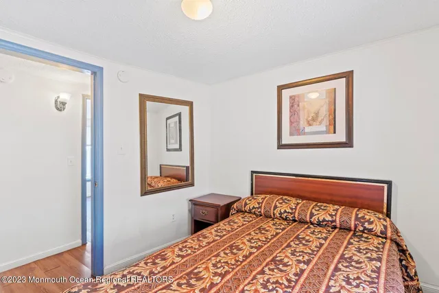 a bedroom with a bed and painting on the wall