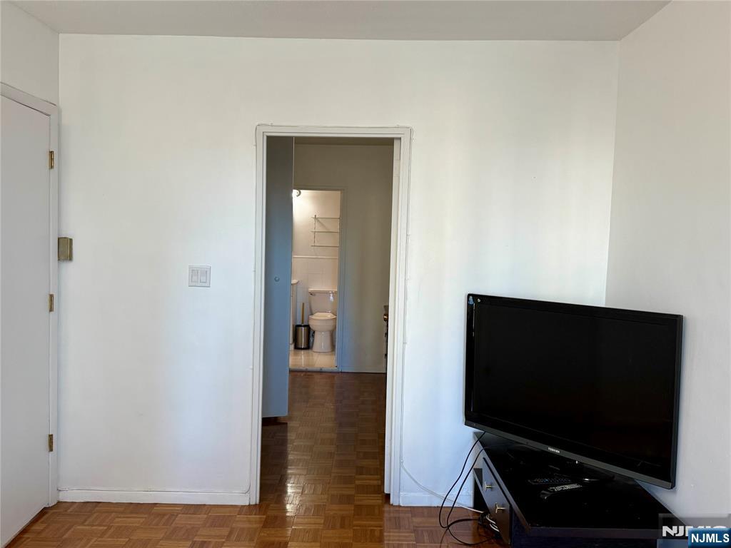 5 Horizon Road, Unit 307 Fort Lee, NJ 07024 - Photo 12 of 31 a living room with flat screen tv and a wooden floor