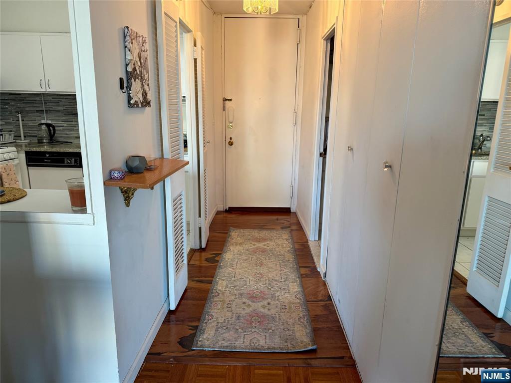 5 Horizon Road, Unit 307 Fort Lee, NJ 07024 - Photo 15 of 31 a view of a hallway with wooden floor and staircase