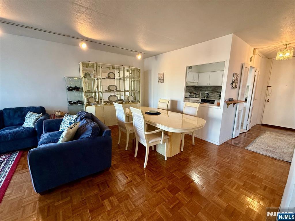 5 Horizon Road, Unit 307 Fort Lee, NJ 07024 - Photo 16 of 31 a living room with furniture and a flat screen tv