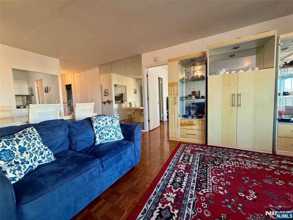 5 Horizon Road, Unit 307 Fort Lee, NJ 07024 - Photo 17 of 31 a living room with furniture and a rug