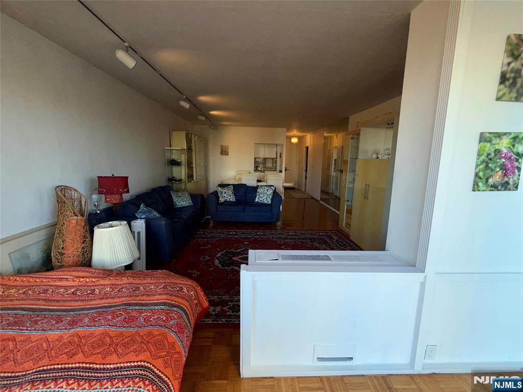 5 Horizon Road, Unit 307 Fort Lee, NJ 07024 - Photo 19 of 31 a bedroom with a bed and wooden floor