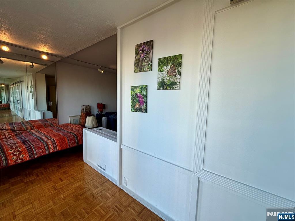 5 Horizon Road, Unit 307 Fort Lee, NJ 07024 - Photo 20 of 31 a bedroom with a bed and a refrigerator