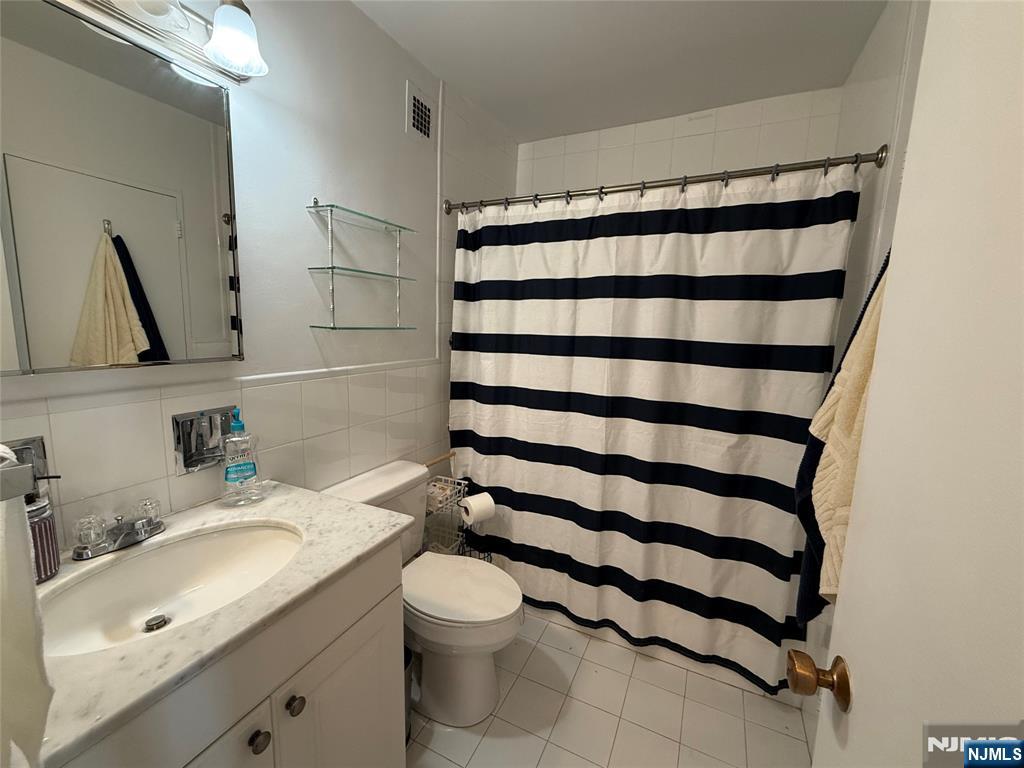 5 Horizon Road, Unit 307 Fort Lee, NJ 07024 - Photo 23 of 31 a bathroom with a sink toilet and shower