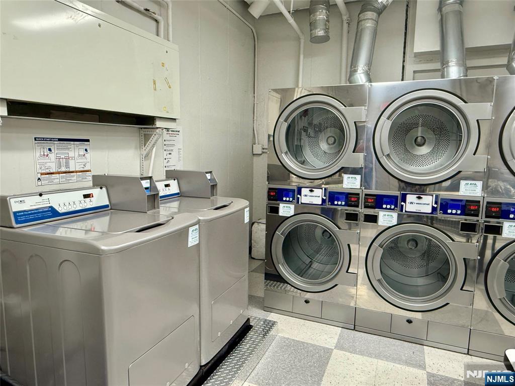 5 Horizon Road, Unit 307 Fort Lee, NJ 07024 - Photo 31 of 31 a utility room with dryer washer and a fireplace