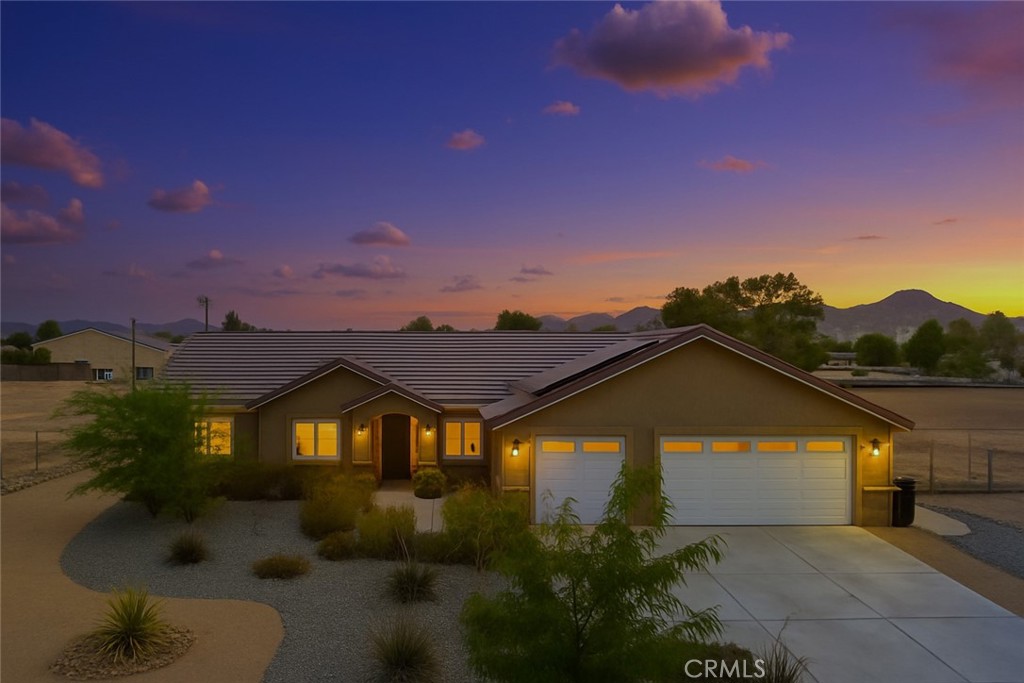 15620 Erie Road Apple Valley, CA 92307 - Photo 5 of 53 a view of a big house with a big yard and large tree