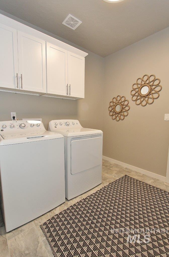 3553 North Eleanor Way Star, ID 83669 - Photo 14 of 20 Laundry area with washing machine and clothes dryer and cabinet space