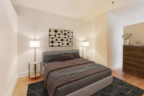 a bedroom with a bed and a night stand