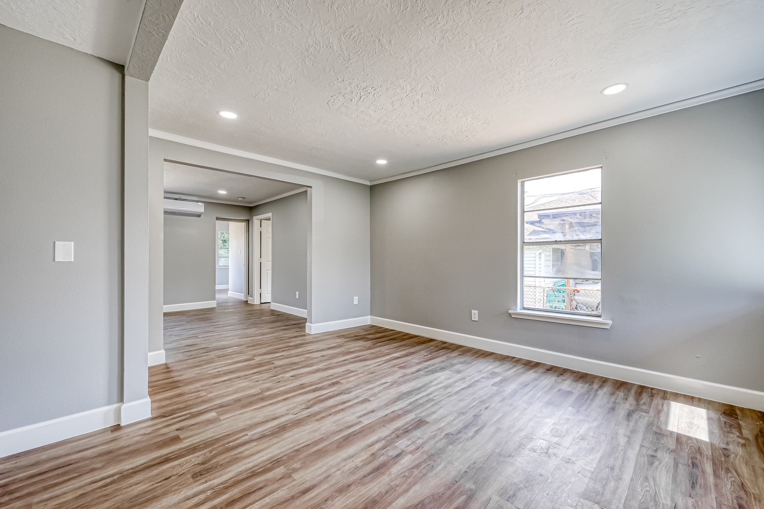 6715 Victoria Street, Unit A Houston, TX 77020 - Photo 8 of 34 a view of an empty room with wooden floor and a window