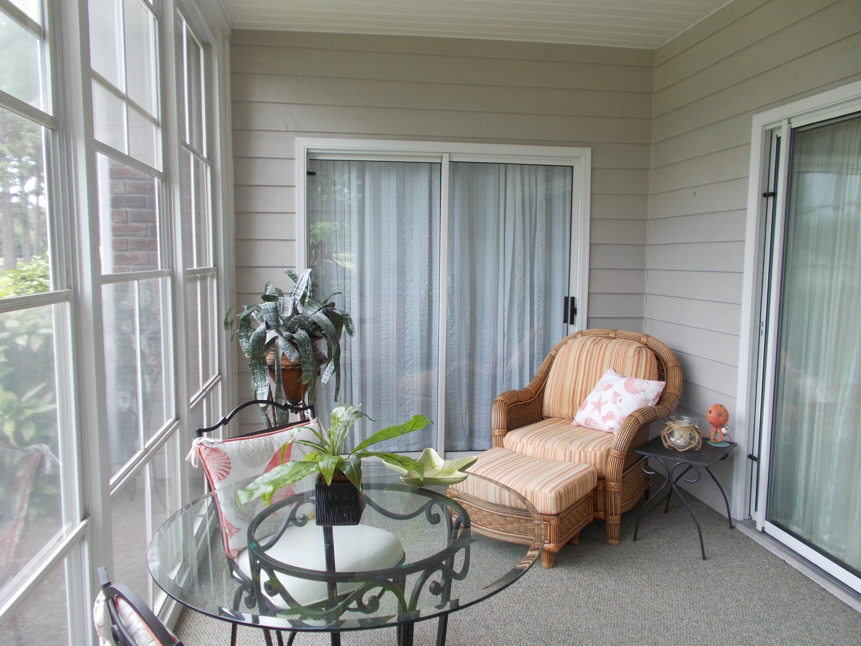 102 Rice Mill Circle, Unit U1 Sunset Beach, NC 28468 - Photo 4 of 17 All season porch with golf views