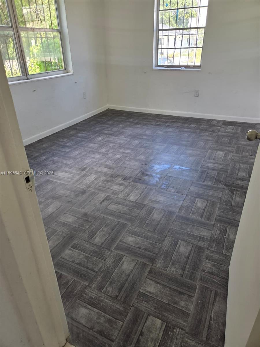 5600 Northwest 7th Court, Unit 14 Miami, FL 33127 - Photo 8 of 8 an empty room with windows